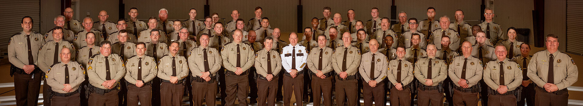 Sheriff and staff standing all together with shirts and ties